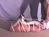 Hogtied Ashley struggling on the floor